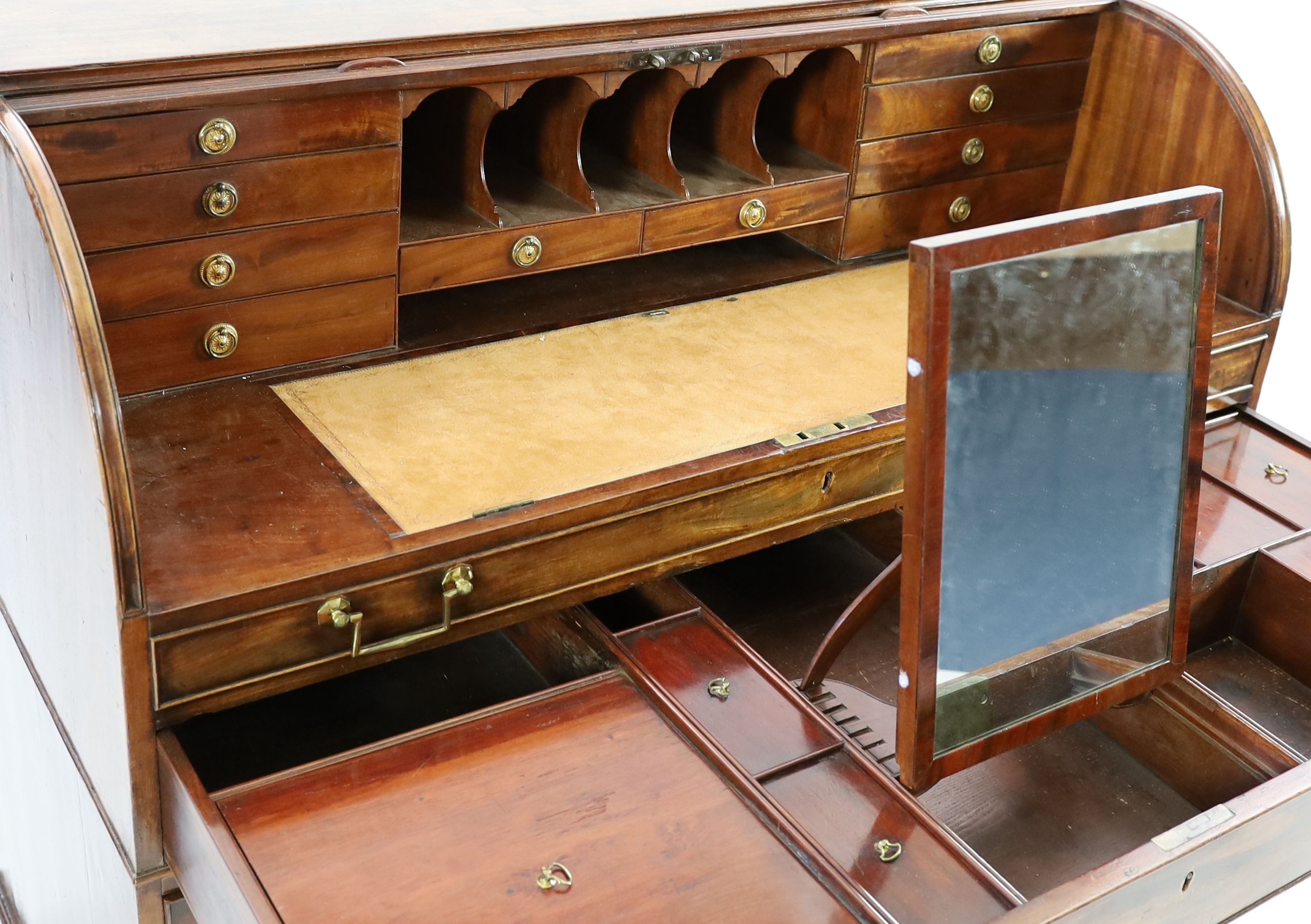 A George III mahogany cylinder top combined writing and dressing kneehole desk, W.122cm D.61cm H.110cm